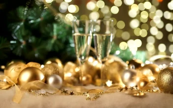 Stock Video Gold Holiday Ornaments And Champagne Glasses On Green Bokeh For PC