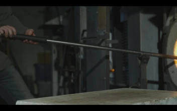 Stock Video Glazier Taking Glass Out Of A Furnace And Shaping It For PC