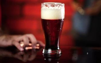 Stock Video Glass Of Beer In The Center Of A Table At For PC