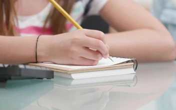 Stock Video Girl Writes Notes While Learning In Classroom For PC