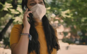 Stock Video Girl With A Mask On The Street Answers A Call For PC