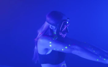 Stock Video Girl With A Mask Dancing Under A Party Light For PC
