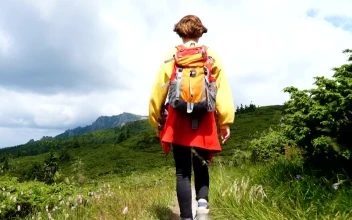 Stock Video Girl With A Backpack Hiking In The Hills For PC