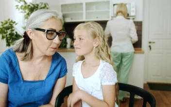 Stock Video Girl Whispers To Grandma While Mom Cooks For PC