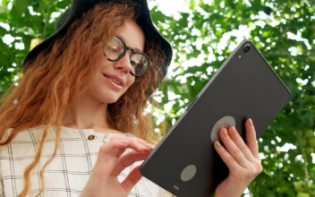 Stock Video Girl Using A Big Tablet In A Garden For PC