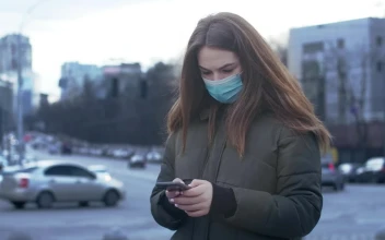 Stock Video Girl Texting With Face Mask On The Street For PC