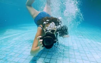 Stock Video Girl Taking Underwater Photos In A Swimming Pool For PC