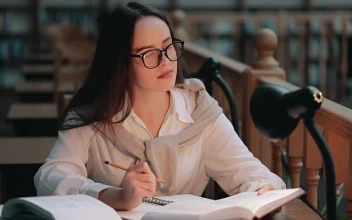 Stock Video Girl Studies Late In Library To Prepare For Exam For PC