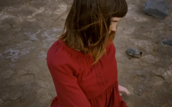 Stock Video Girl Stretching With Her Body Sitting In A Desert For PC