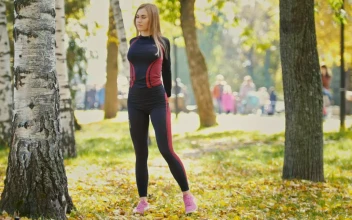 Stock Video Girl Stretching And Warming Up In A Sunny Park For PC