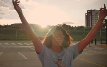 Stock Video Girl Skating Down The Street In A Close Shot For PC