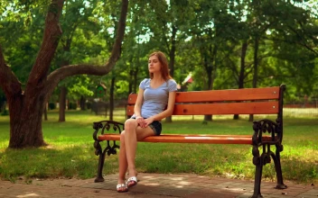 Stock Video Girl Sitting On A Bench Waiting For Someone For PC