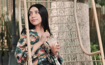 Stock Video Girl Sitting In A Hanging Chair Enjoying A Cold Coffee For PC