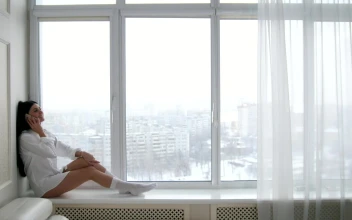 Stock Video Girl Sitting At The Bottom Of A Window On A For PC