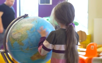 Stock Video Girl Rotating An Earth Globe At School For PC
