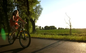 Stock Video Girl Riding A Bike On A Warm Evening For PC