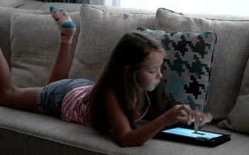 Stock Video Girl Relaxing With A Tablet Game For PC