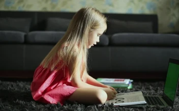 Stock Video Girl Reading In Front Of The Laptop At Home For PC