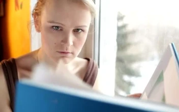 Stock Video Girl Reading A Large Book By The Window  Smal For PC