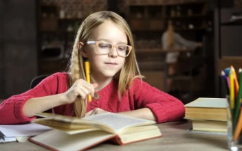 Stock Video Girl Reading A Book While Writing For PC