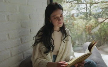 Stock Video Girl Reading A Book Sitting Near A Window For PC