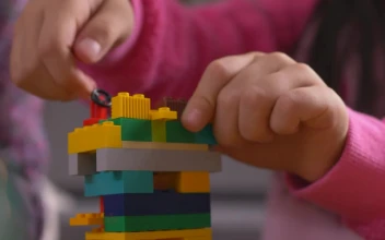 Stock Video Girl Putting Together A Figure With Legos For PC