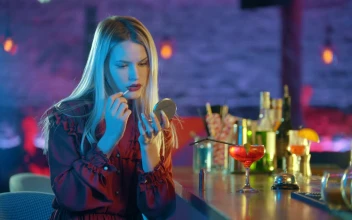 Stock Video Girl Putting On Makeup Sitting At A Bar For PC