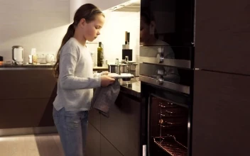 Stock Video Girl Putting Cookies In An Oven For PC