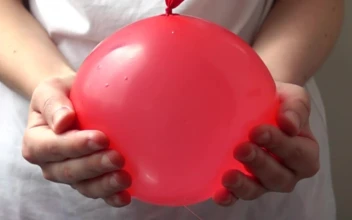 Stock Video Girl Popping A Water Balloon For PC
