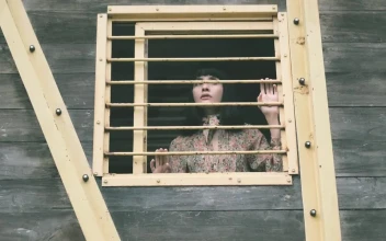 Stock Video Girl Peeking Out Of The Window Of An Old Cabin For PC
