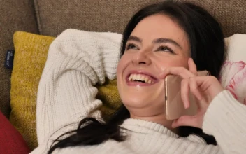 Stock Video Girl On A Sofa Laughing During A Phone Call For PC