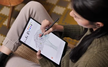 Stock Video Girl On A Sofa Coloring Flowers On A Tablet For PC
