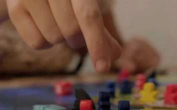 Stock Video Girl Moving Small Figures From A Board Game For PC