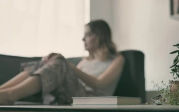 Stock Video Girl In The Living Room Starts Reading A Book For PC