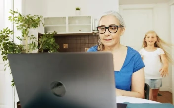 Stock Video Girl Greets Grandma While She Works On Laptop For PC