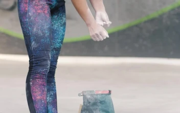 Stock Video Girl Filling Her Hands With Chalk Before Practicing Mountaineering For PC