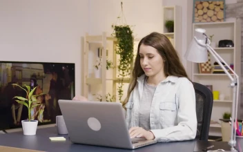 Stock Video Girl Drinking Coffee And Typing On Laptop At Home For PC