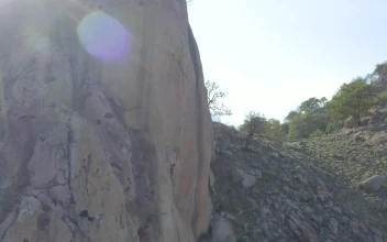 Stock Video Girl Descending A Rocky Hill With The Help Of A For PC