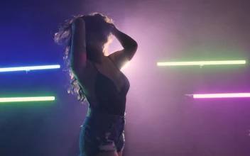 Stock Video Girl Dancing On A Dark Floor Under Colored Lights For PC