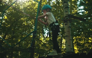 Stock Video Girl Crossing The Ropes In The Woods For PC