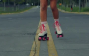 Stock Video Girl Approaching Skating Down The Middle Of The Street For PC