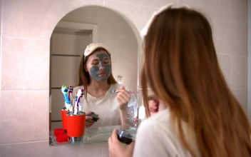 Stock Video Girl Applying A Mask In Front Of A Mirror For PC