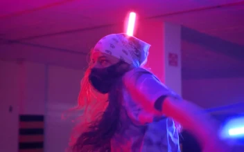 Stock Video Girl And Boy With Masks Dancing Under Colored Lights For PC