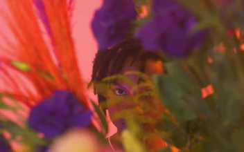 Stock Video Gay Boy Looking Straight Through Flowers For PC