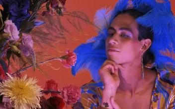 Stock Video Gay Boy Dressed And Made Up Extravagantly Among Flowers For PC