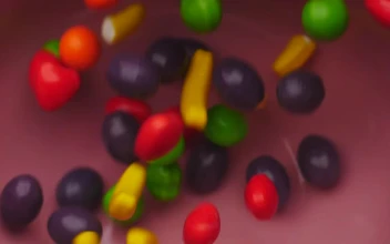 Stock Video Fruit Shaped Candies Falling Into Bowl For PC