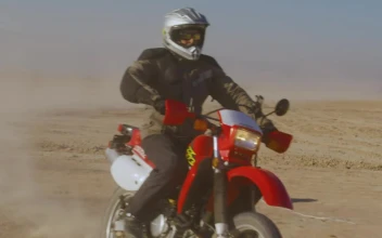Stock Video Frontal Tracking Shot Of A Biker In The Desert For PC