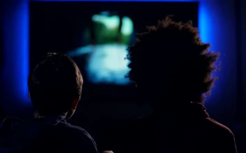 Stock Video Friends Watching A Film In A Dark Room For PC