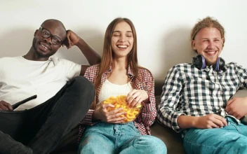 Stock Video Friends Watching A Comedy Show On Tv For PC
