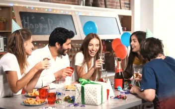 Stock Video Friends Laugh Over Champaign At Birthday Party For PC
